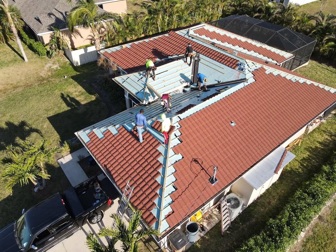 Aerial view of full crew installing tile roof